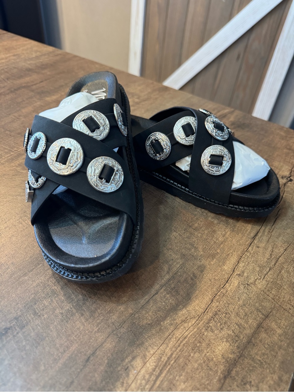 Women’s Black Slide Sandals with Silver Medallion Details